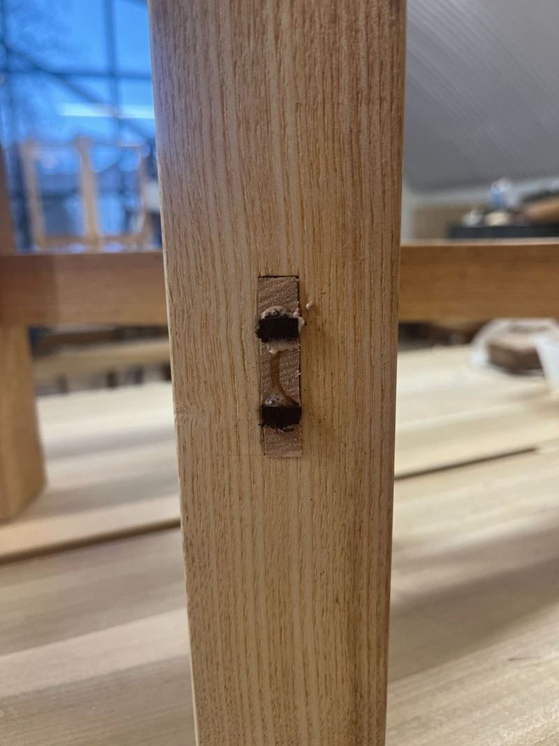 Mortise in table leg — marked with pegs and cut to clean walls