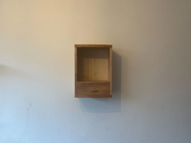 Ash wall cabinet installed — front view