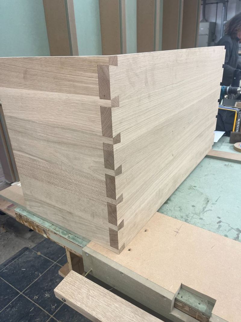 Dry fit — both leg panels test-fitted with through-dovetails