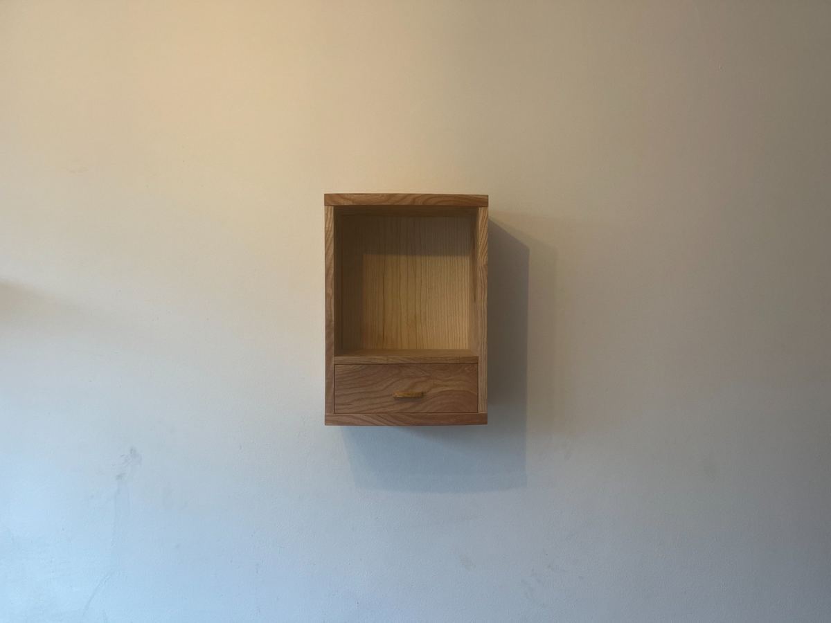 Ash wall hanging cabinet with a piston-fit drawer