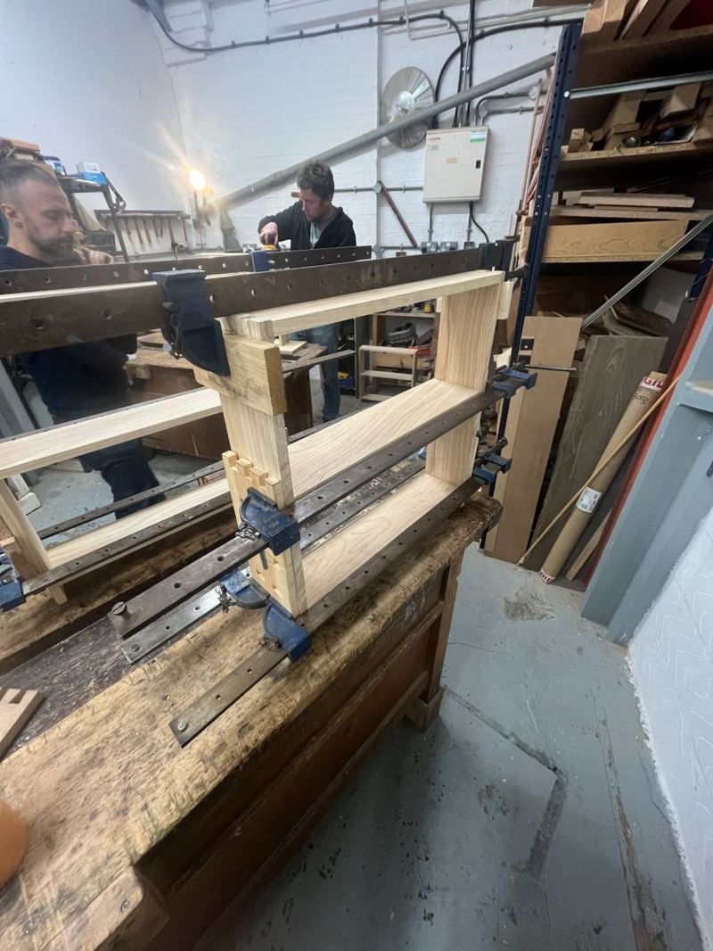Shelf frame under clamps during glue-up — checking for square